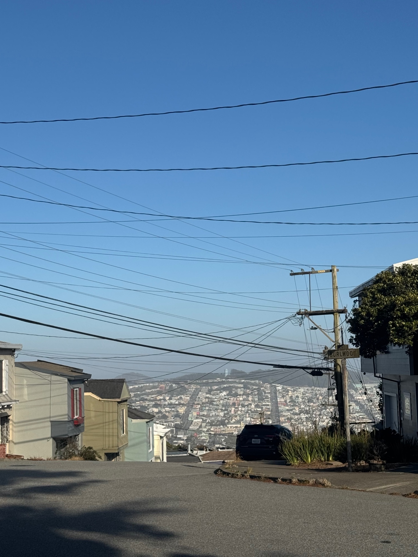 Burlwood Drive street sign at the top of the hill with the city spread out below